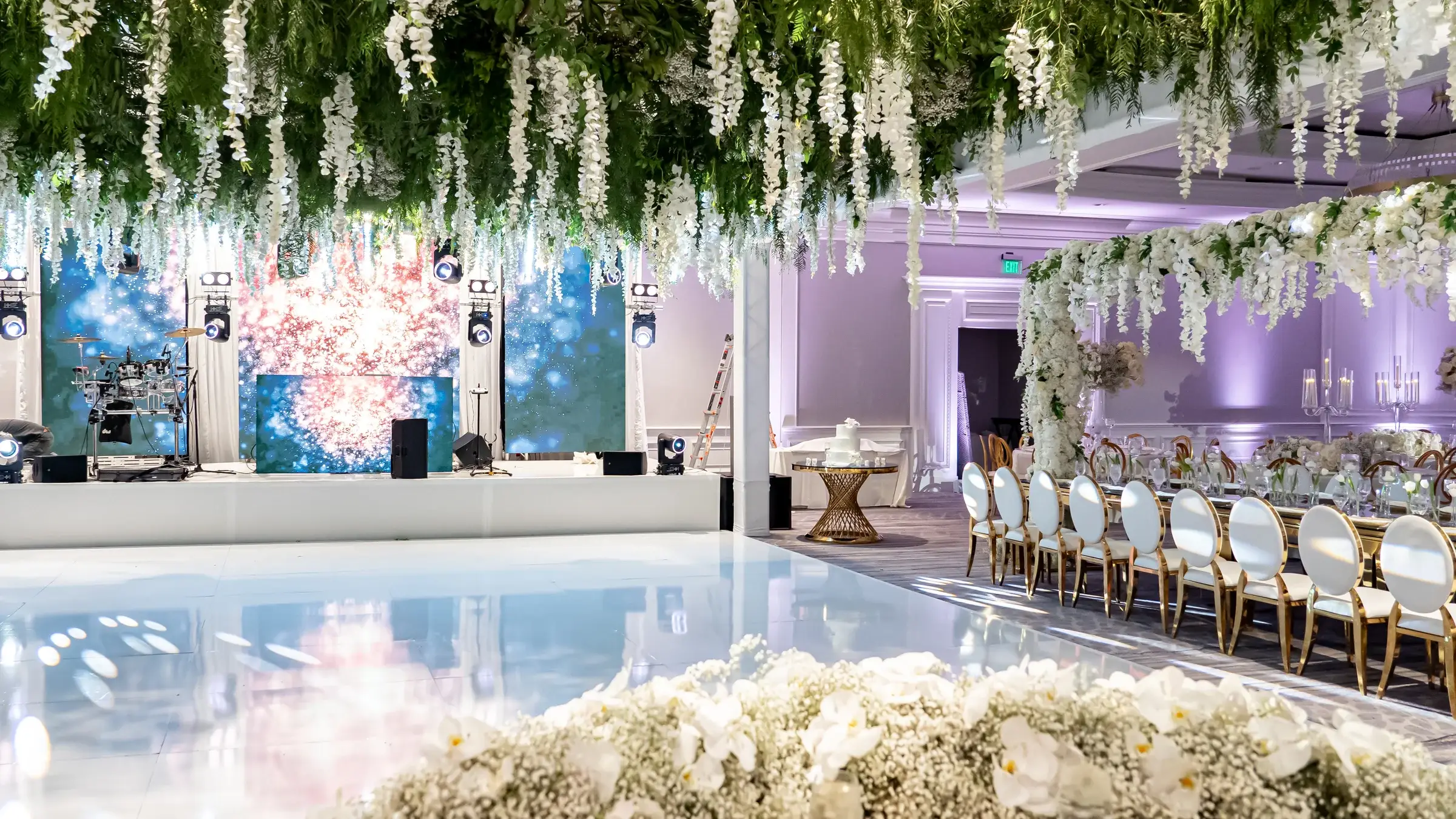 Reception with LED walls, lavender uplighting and a hanging floral ceiling at The Ritz-Carlton, Marina del Rey