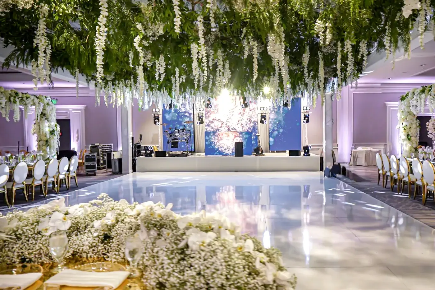 LED video walls behind the stage and a white dance floor at a wedding at The Ritz-Carlton, Marina del Rey