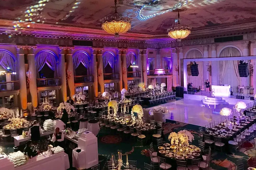 Ballroom lit with intelligent lighting, colored uplighting, and patterned ceiling projections