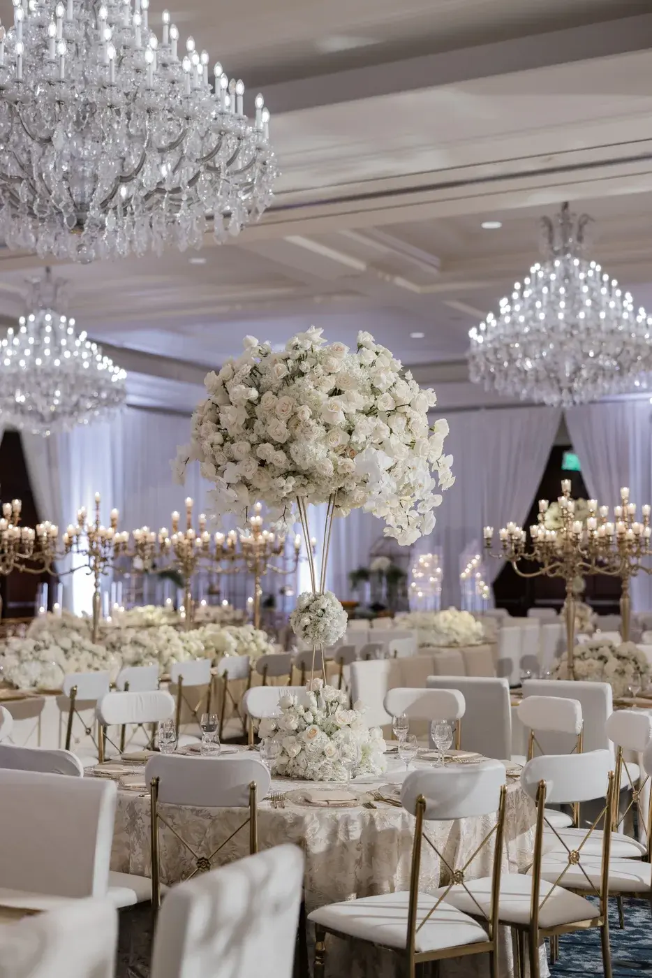 White floral centerpiece and candles in the ballroom at the Four Seasons Hotel Westlake Village.