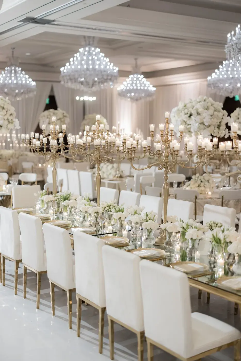 Candlelit long table with gold candelabras and white tulips at the Four Seasons Hotel Westlake Village.