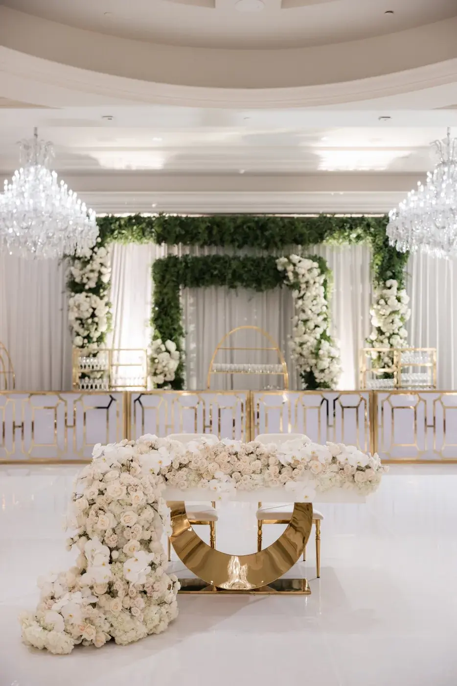 Sweetheart table with cascading white roses in front of a greenery backdrop at the Four Seasons Hotel Westlake Village.