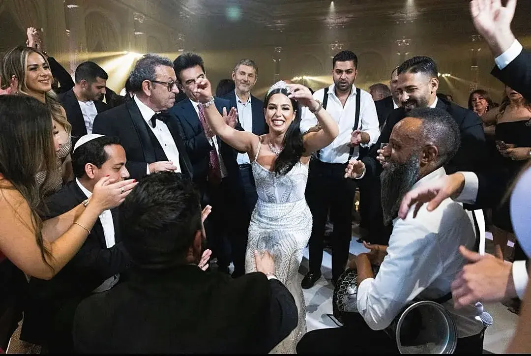 Bride dancing in the center of a celebration circle with live percussion and cheering guests at a luxury Los Angeles wedding