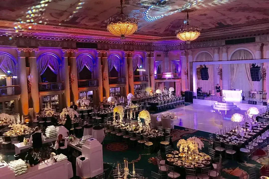 Ballroom lit with intelligent lighting, colored uplighting, and patterned ceiling projections