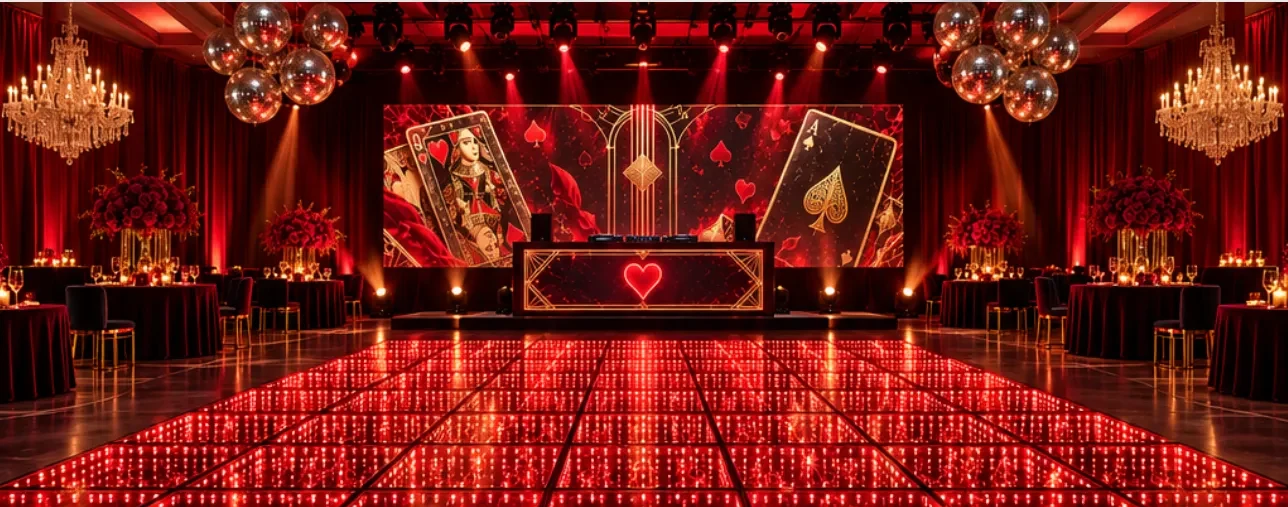 Illustrative concept: a ballroom with a deep red color-changing LED dance floor, a playing-card themed LED backdrop, red uplighting and mirror balls